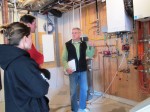 Bruce explains the in floor heating system to the homeowners